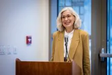 Professor Dorothea Olkowski standing at a podium speaking